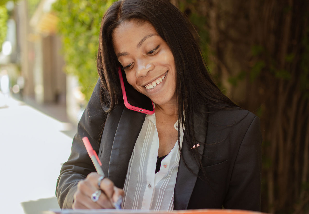 Girl smiling and writing on a book