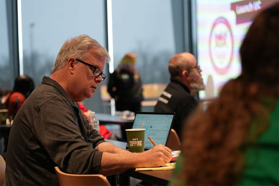 Male writing in an IT classroom 