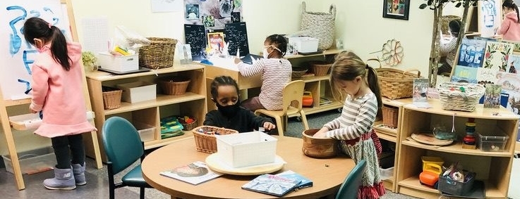 Young preschool students work together in a classroom