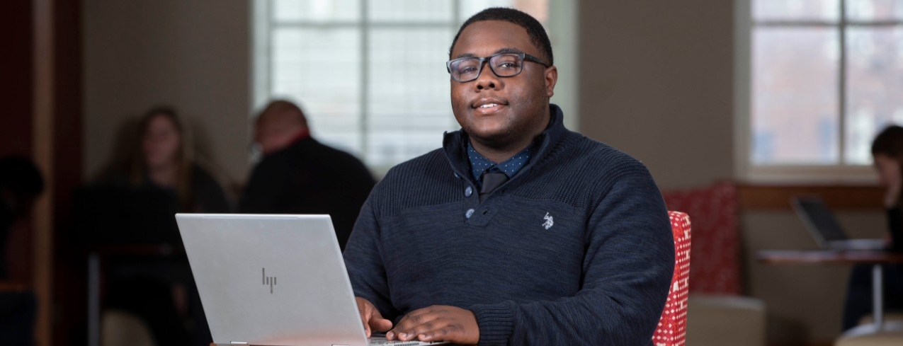 A student in a mask works in a University of Cincinnati lab