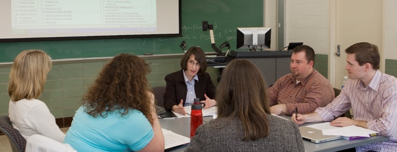 A group of University of Cincinnati students converse in an outdoor class