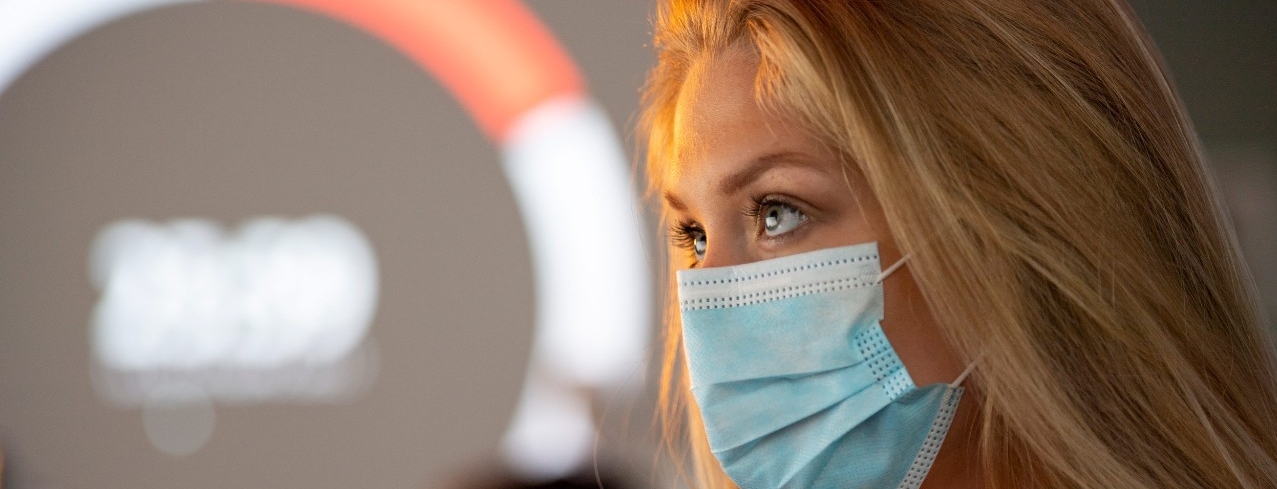 A student in a mask works in a University of Cincinnati lab