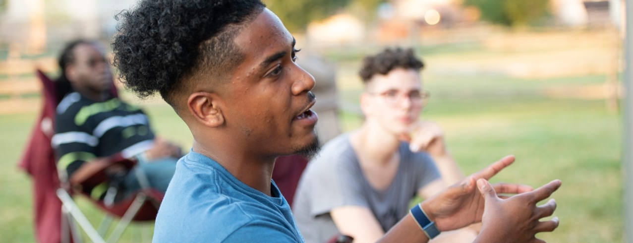 A group of University of Cincinnati students converse in an outdoor class