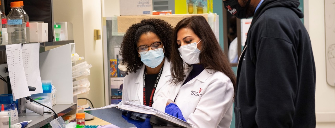 Masked students working collaboratively in a University of Cincinnati lab