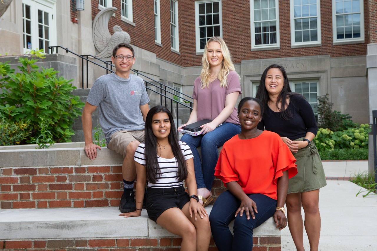 Four CECH students sitting outside.